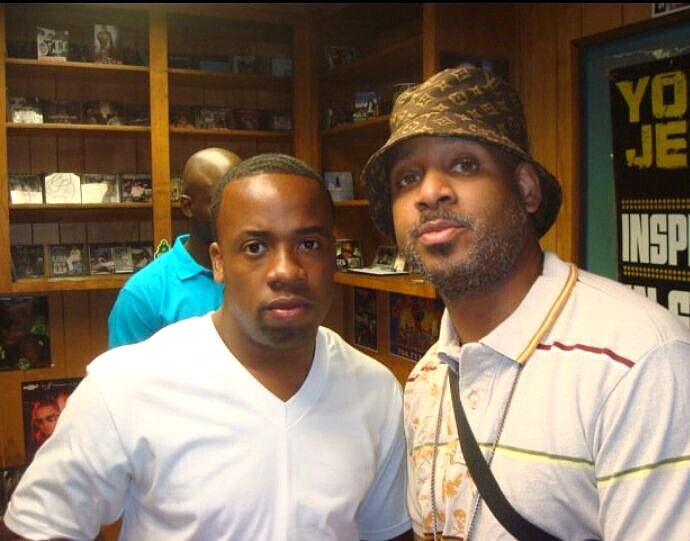 Celebrity DJ Cat-X consulting an independent hip-hop artist inside a record store during a real DJ promo campaign